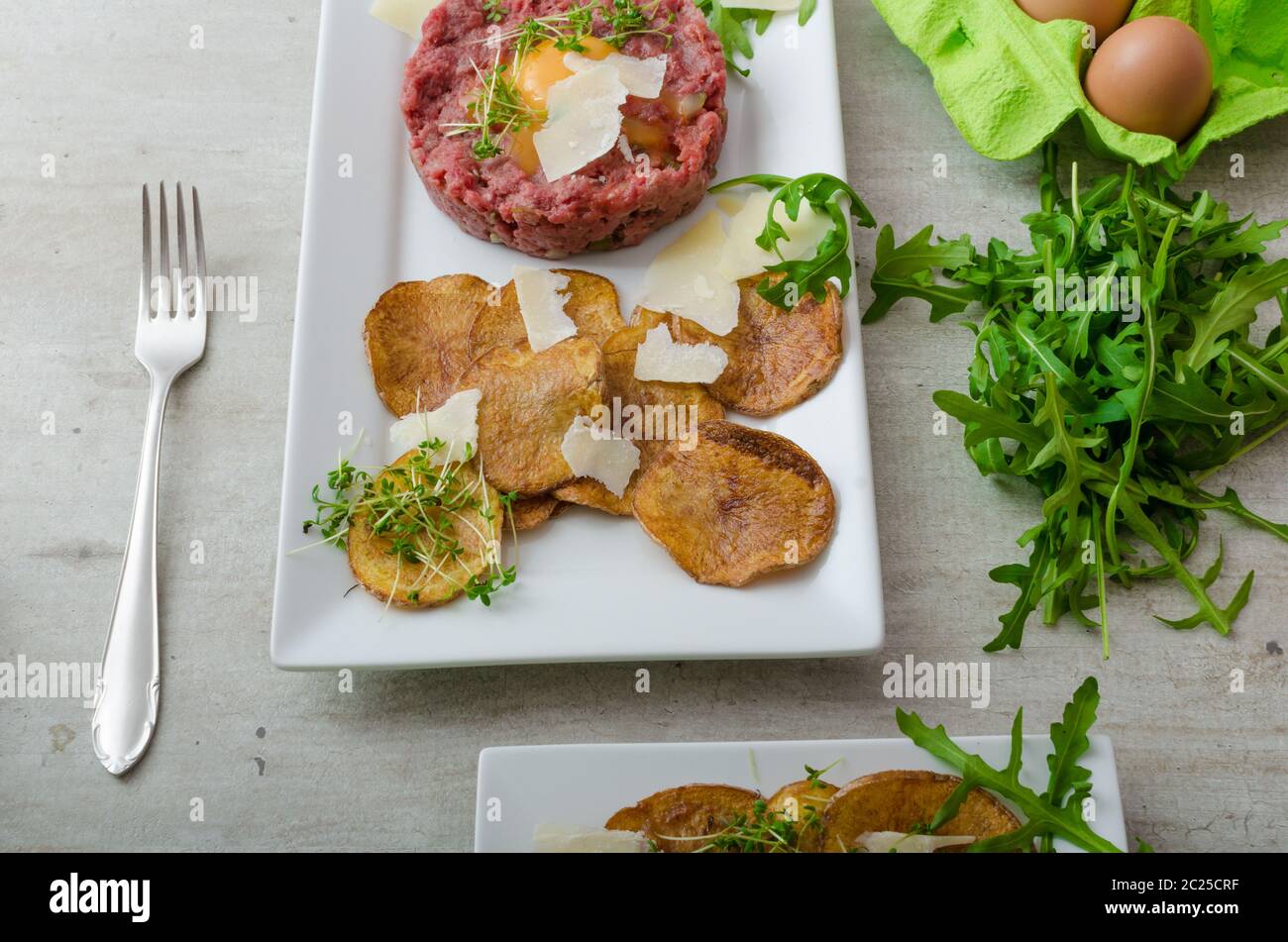 Beef Tartar Homemade Potato Chips Sprinkled With Parmesan Shavings And Microgreens Stock Photo Alamy