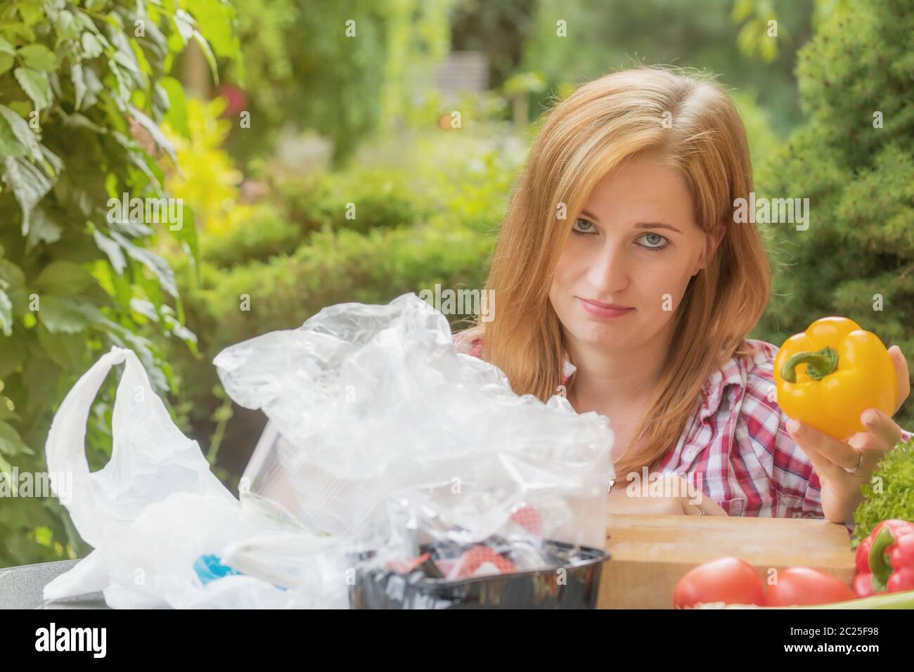Sad young woman is showing how much plastic packaging remains after
