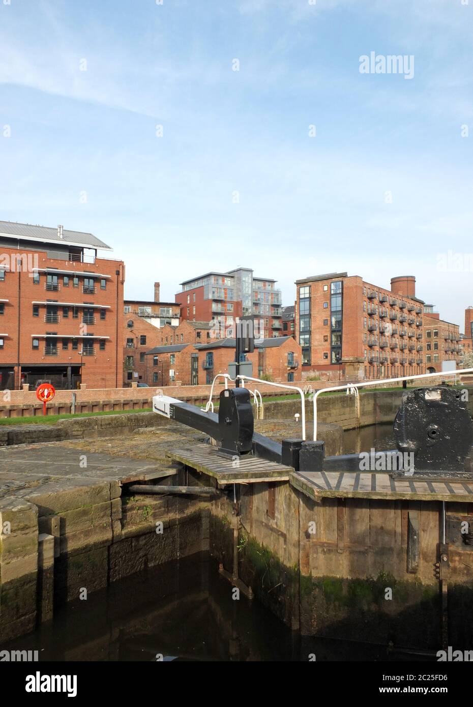 old wooden lock gates on the canal in leeds city center surrounded by