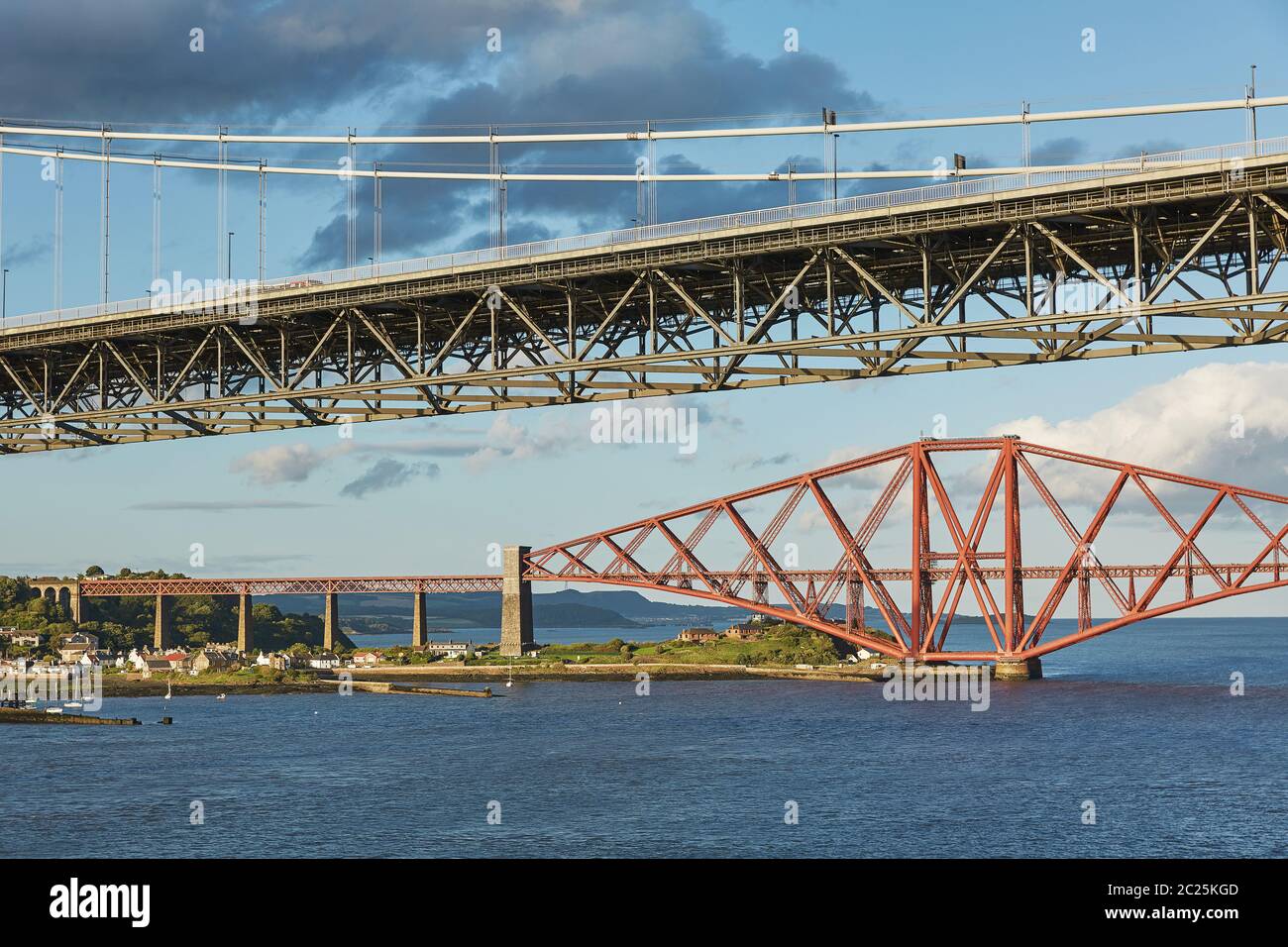 Older Forth Road bridge and the iconic Forth Rail Bridge in Edinburgh Scotland. Stock Photo