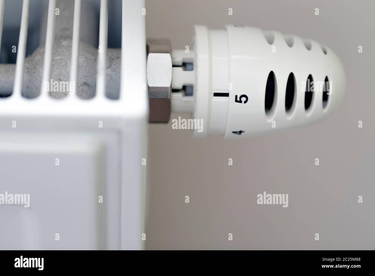 Heating radiator with temperature regulator close-up Stock Photo