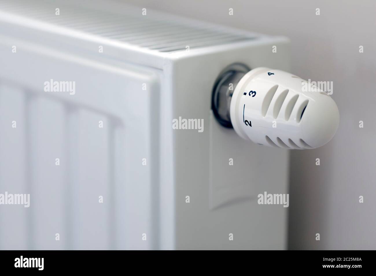 Heating radiator with temperature regulator close-up Stock Photo