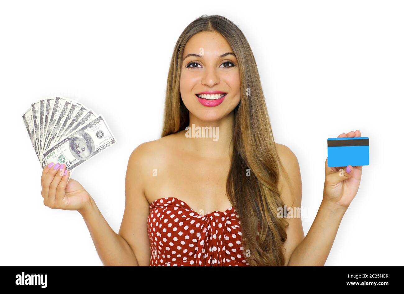 Portrait of a smiling young woman showing bunch of money banknotes and holding plastic credit card isolated over white background. Stock Photo