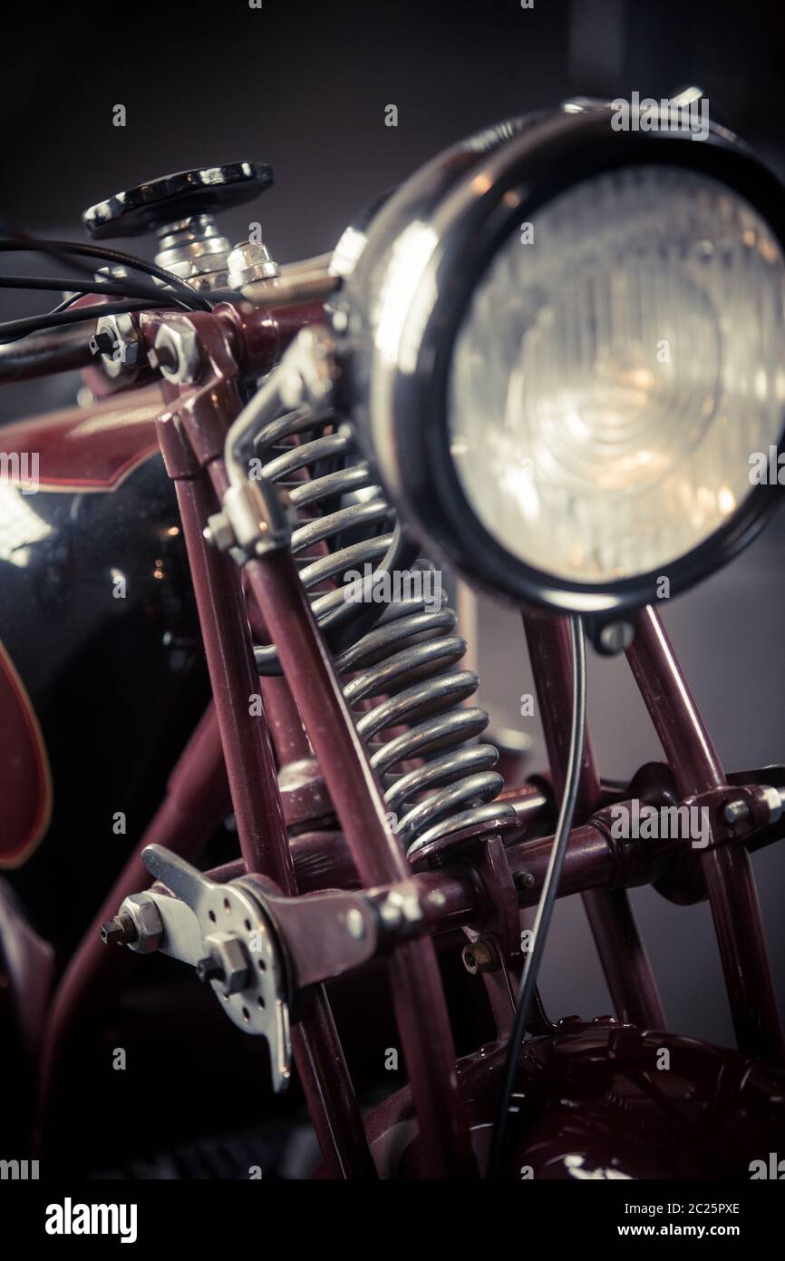 Color vertical close up of the front suspension of a red vintage