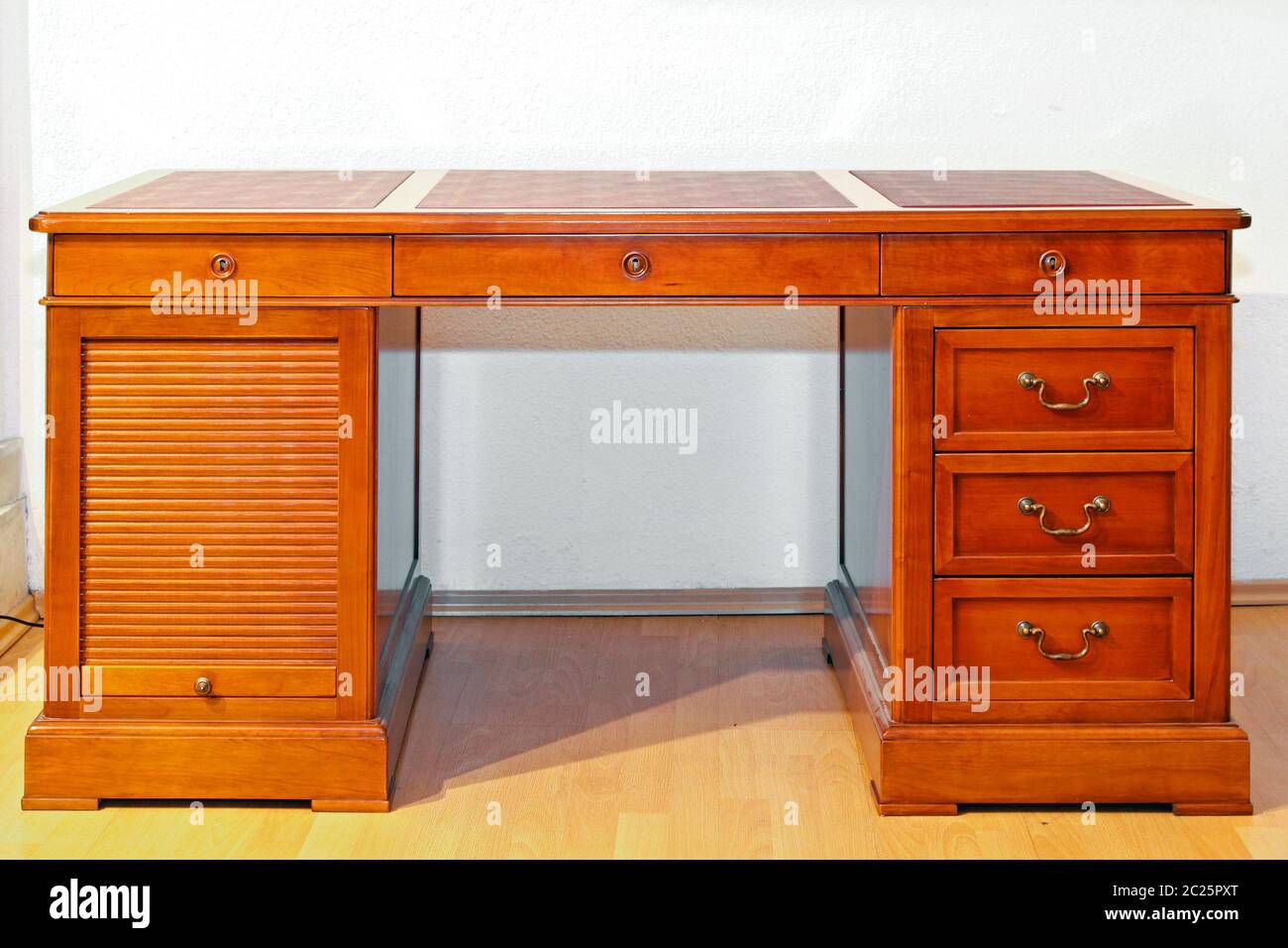 Wooden desk with drawers and roll Stock Photo Alamy