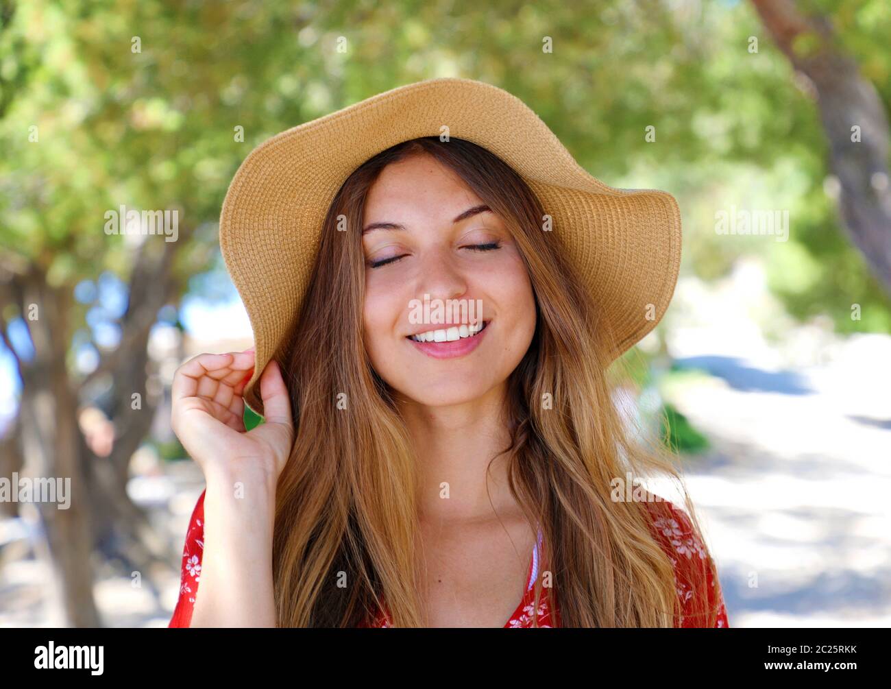 Close up portrait of a beautiful smiling girl with closed eyes wearing ...
