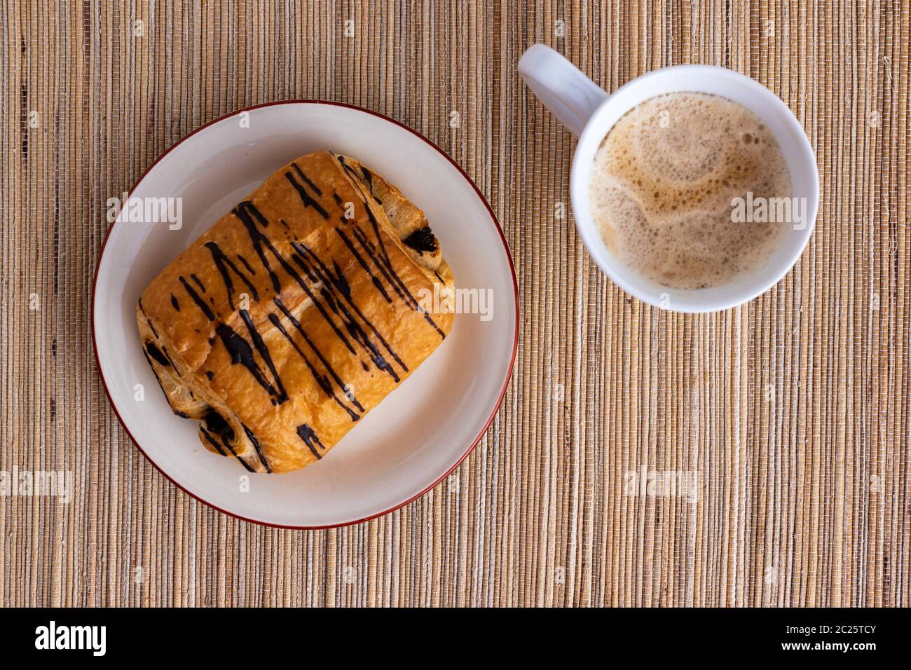 A Chocolate Croissant with Coffee Stock Photo Alamy