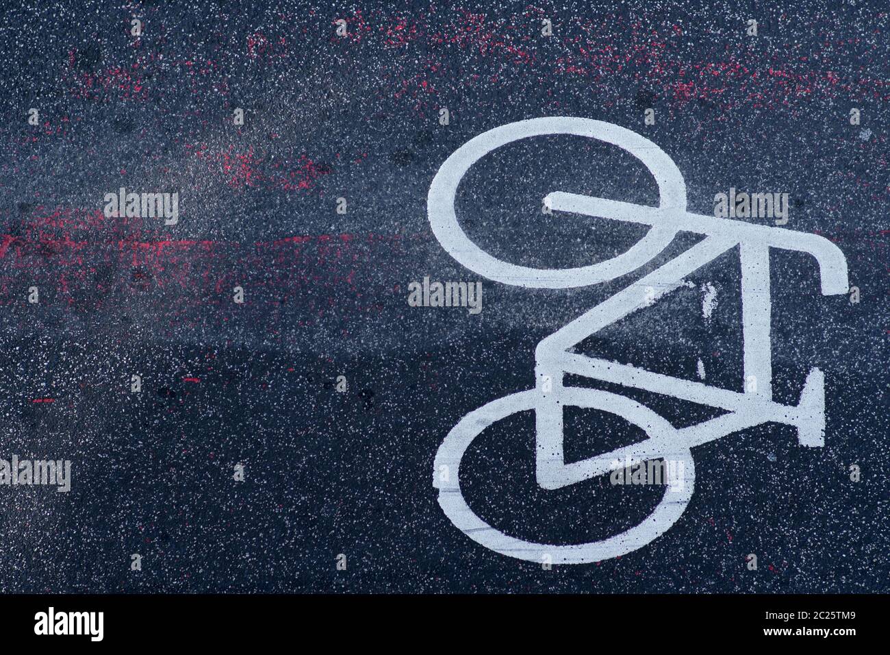 The top view on the road marking and the symbol of a bicycle lane on the asphalt. Stock Photo