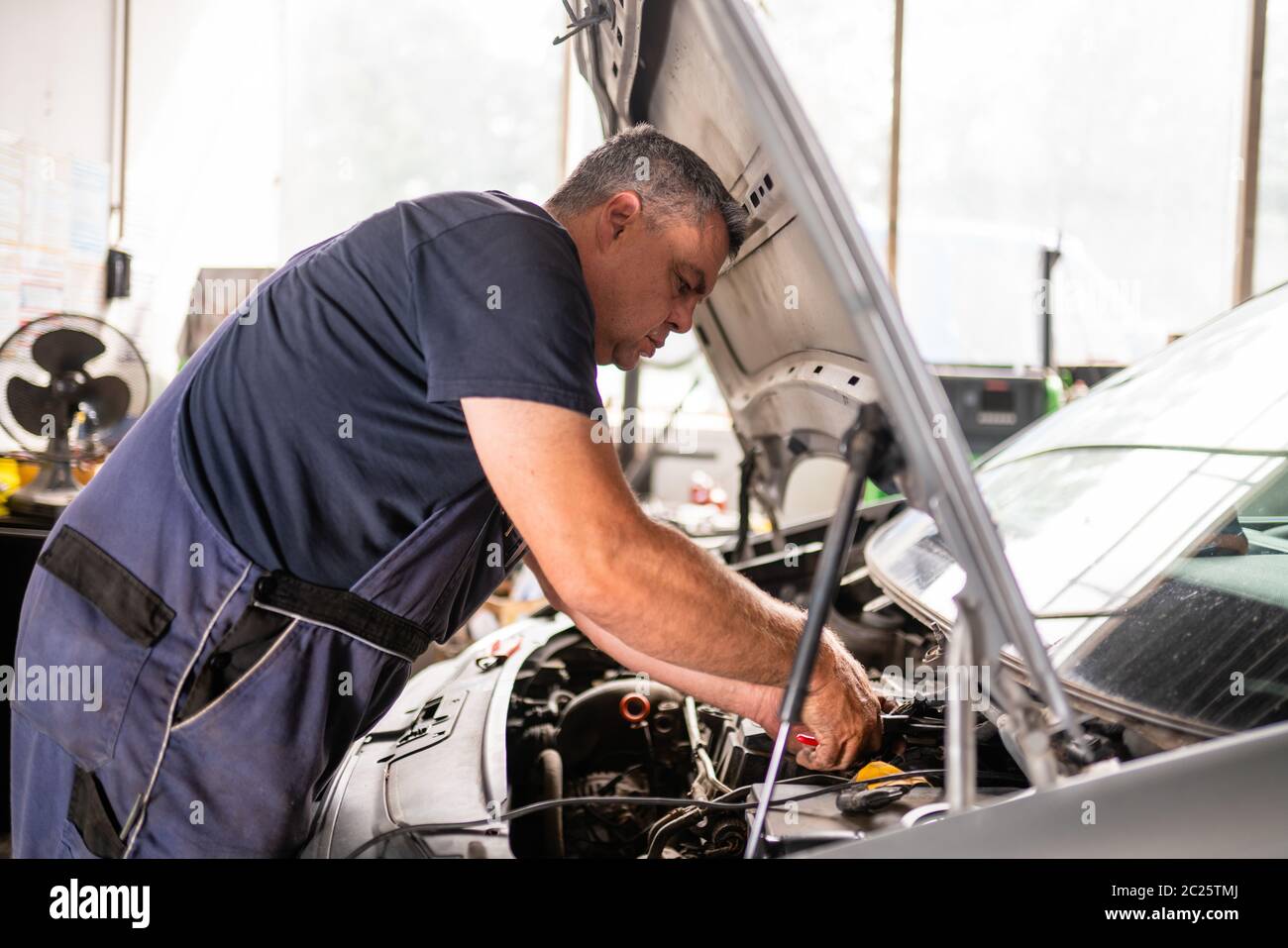 Auto mechanic repairs car 2 Stock Photo