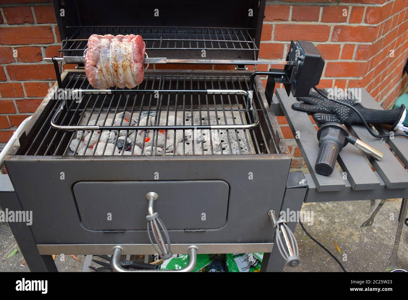 Cooking rotisserie beef roast skewered lengthwise Meat roasted over a