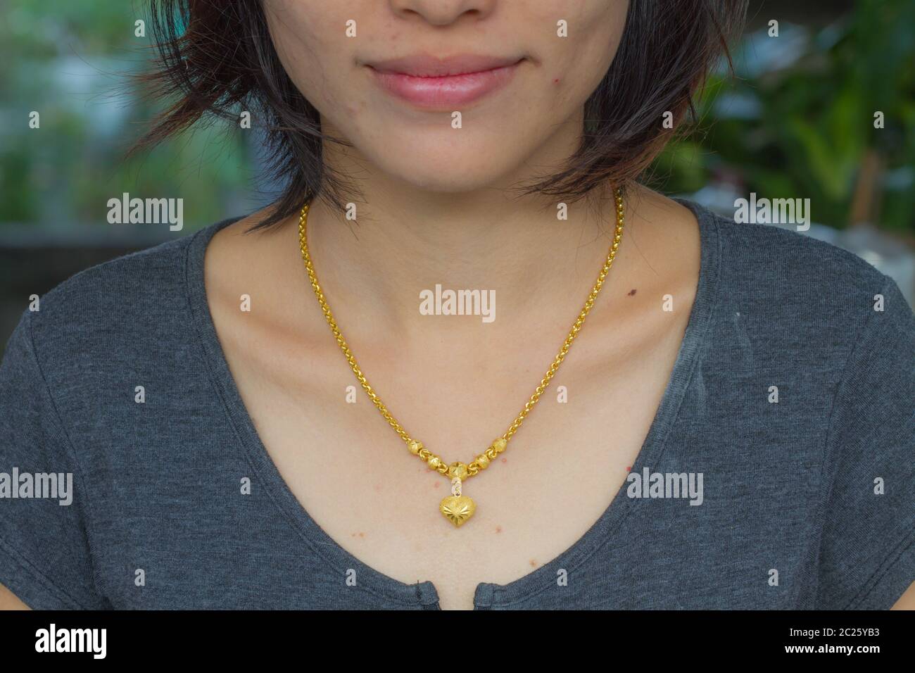 Woman wearing necklace chain hi-res stock photography and images - Alamy