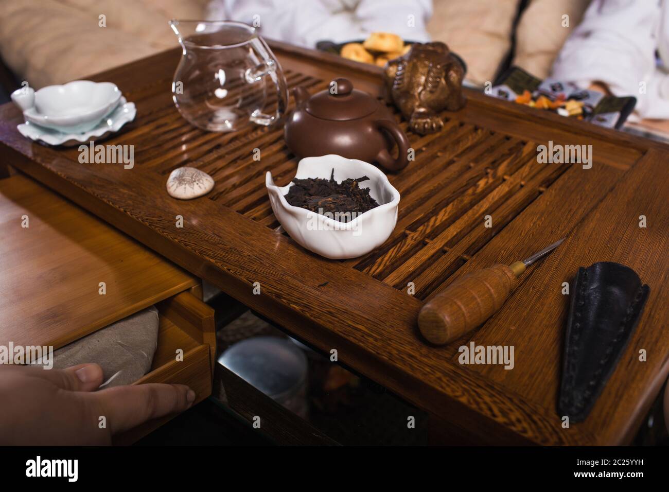 A wooden cutting board with a cake on a table Stock Photo