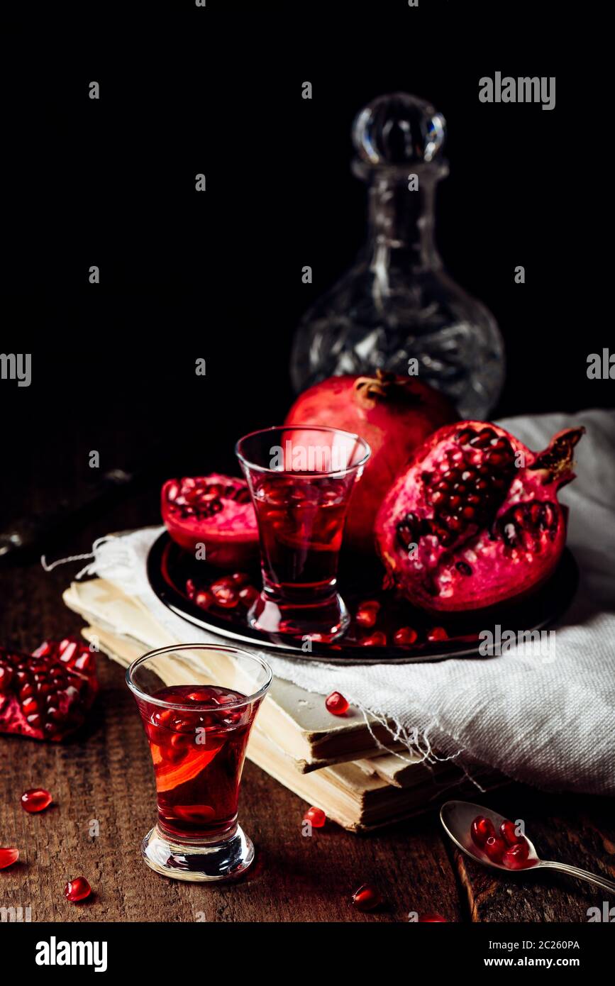 Shots of pomegranate cocktail with vodka and juice Stock Photo