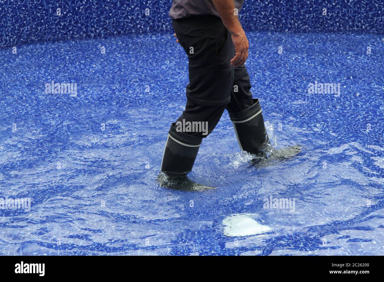 Legs with boots walking through water Stock Photo Alamy