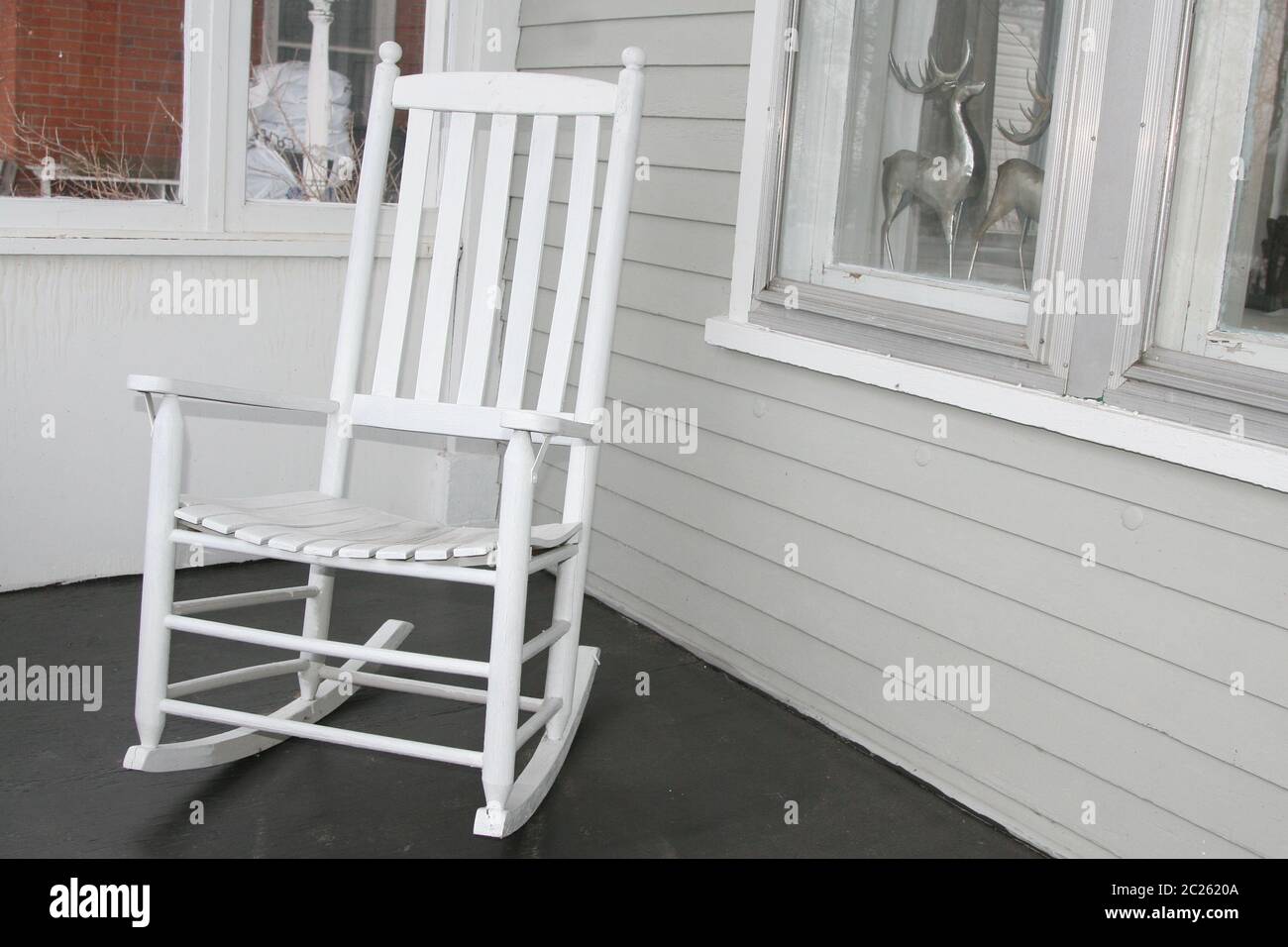 White rocking chair on porch Stock Photo