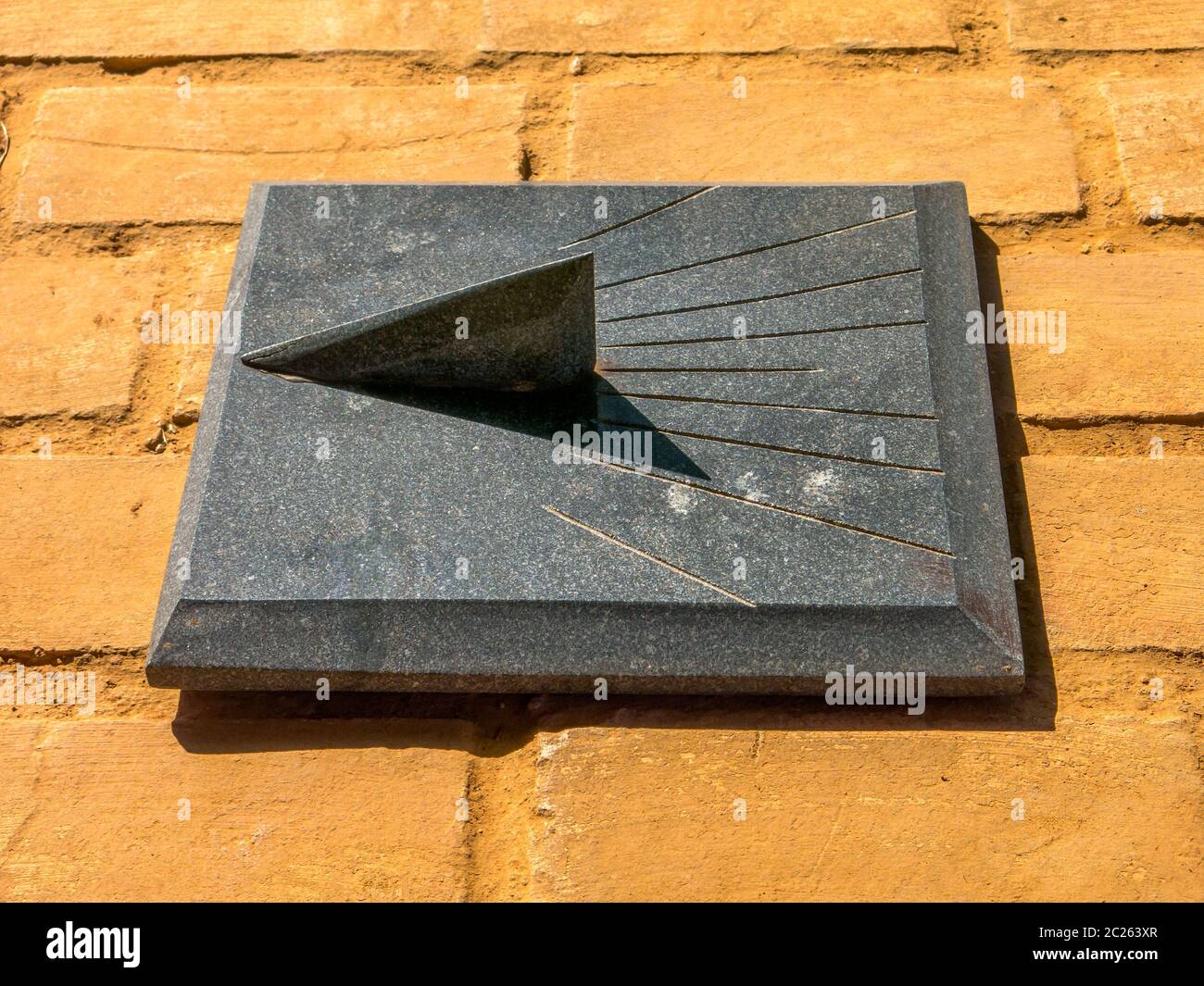 Granite Sundial - sun clock on orange brick floor Stock Photo - Alamy