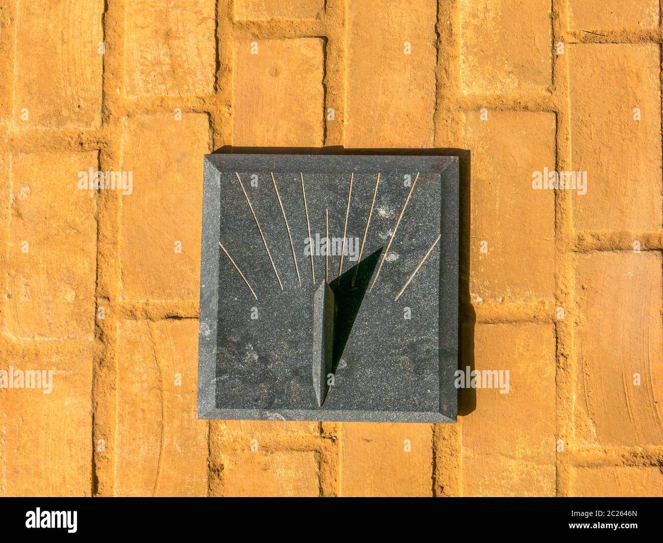 Granite Sundial - sun clock on orange brick floor Stock Photo - Alamy