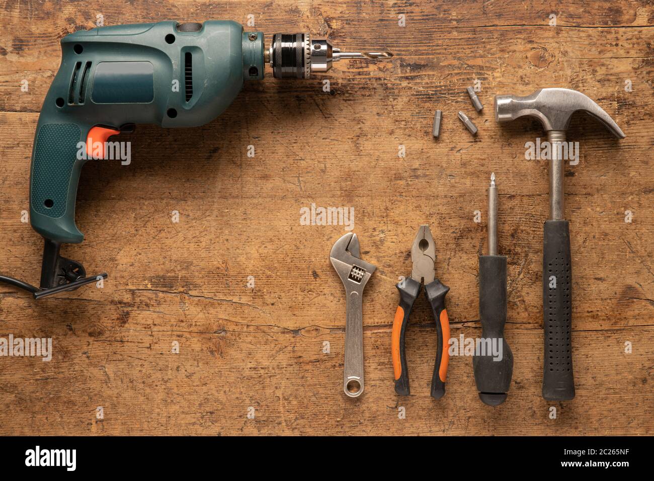 Drill and hand tools on a wooden vintage background Stock Photo - Alamy