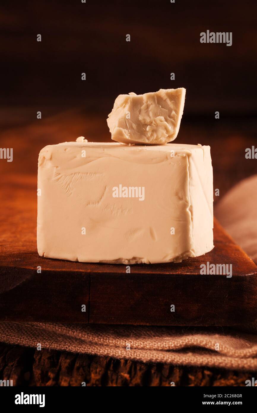 A block of compressed fresh yeast. Stock Photo