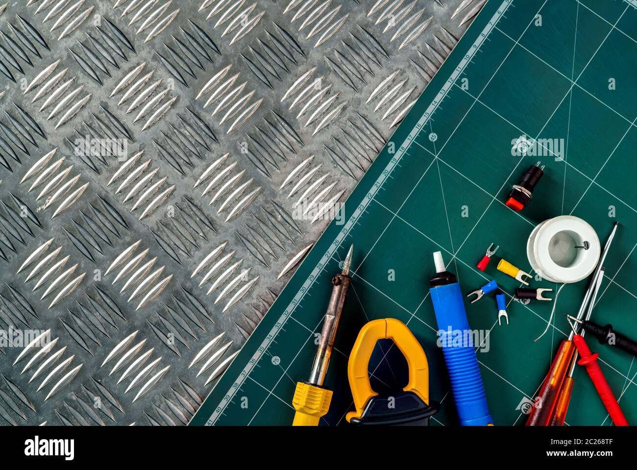 Soldering tools. Soldering iron, spool of soldering wire, screwdriver