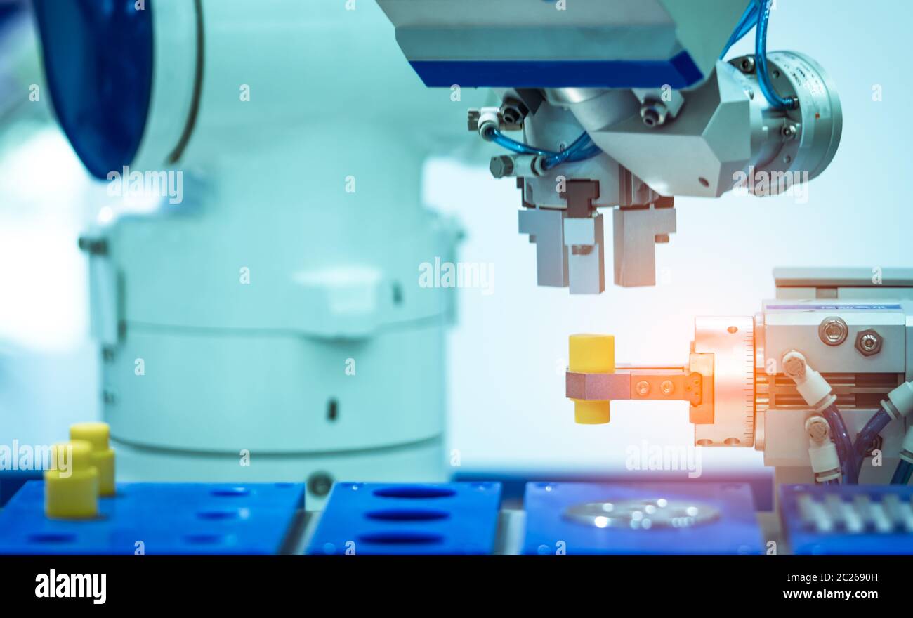 Robot hand machine gripping simulated  object on blurred background. Use smart robot in manufacturing industry. Robotic tool in factory. Robot enginee Stock Photo