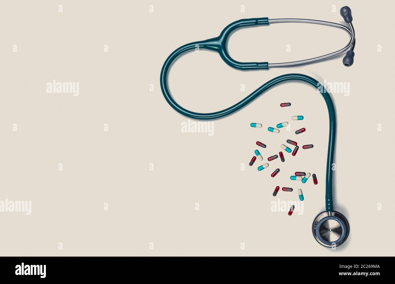 Green stethoscope with pile of capsule pills isolated on white background with copy space