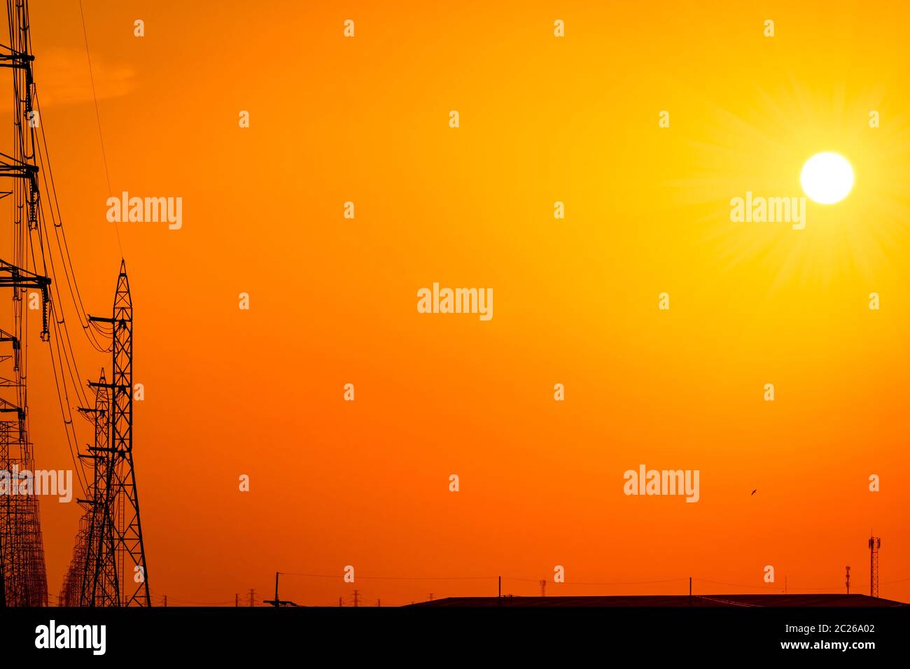 High voltage electric pole and transmission lines in the evening ...