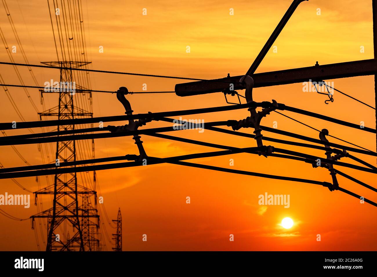 High voltage electric pole and transmission lines in the evening ...