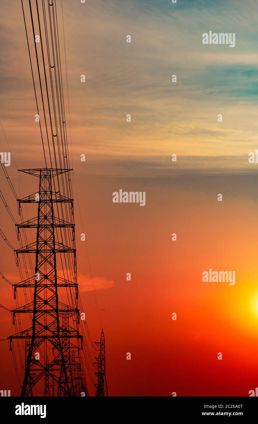 High voltage electric pole and transmission lines in the evening ...