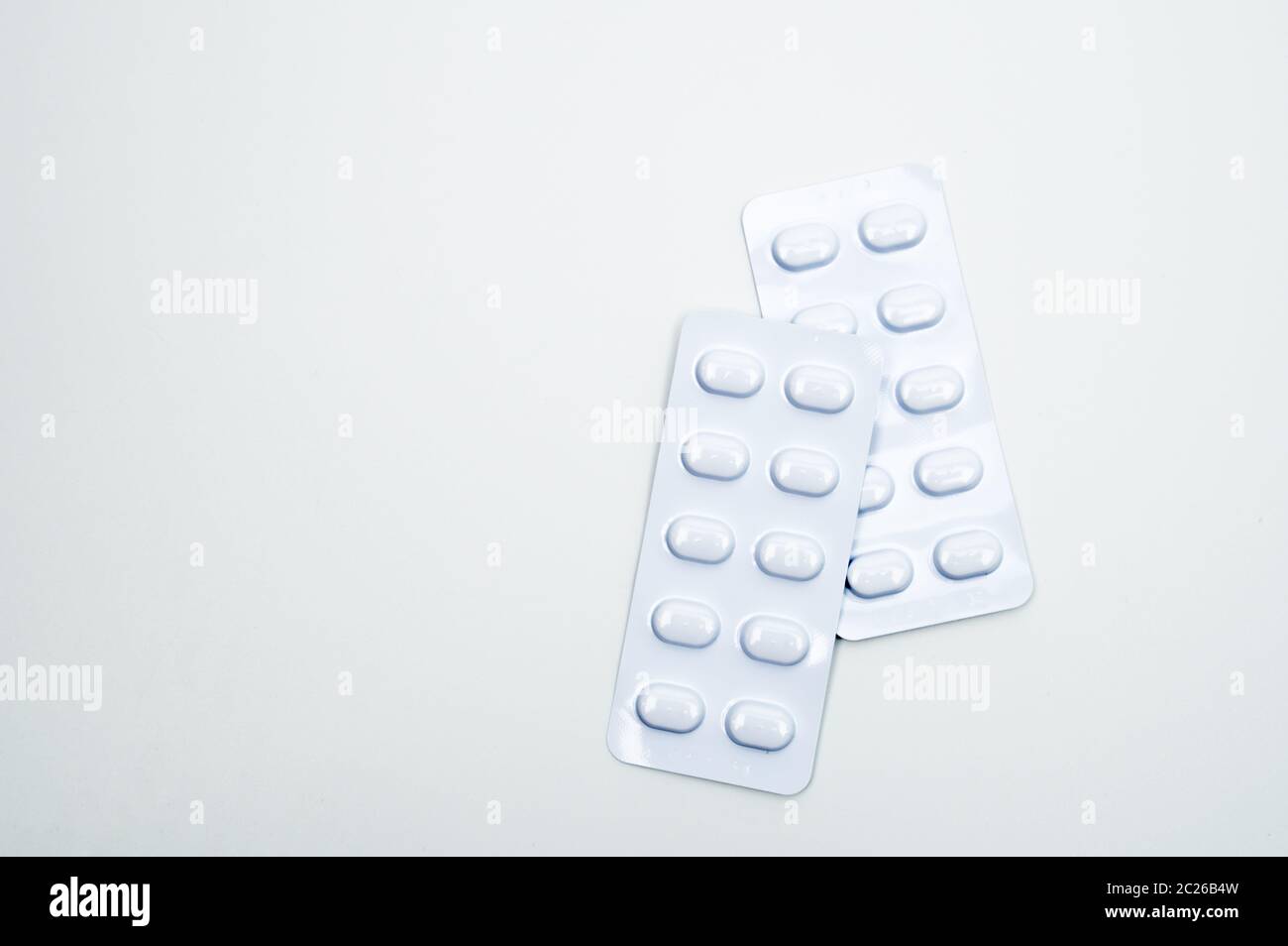 Tablets pill in white blister pack for light resistance packaging isolated on white background. Medicine for treatment NCDs. Elderly people disease. Stock Photo