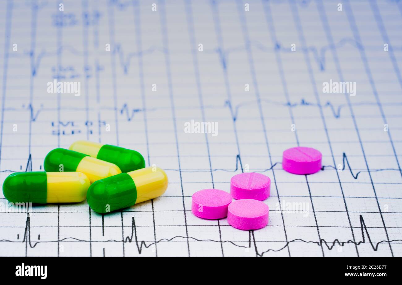 EKG or ECG (Electrocardiogram) graph report paper. EST ( Exercise Stress Test ) result and pills. Package promotion for heart check up in senior or el Stock Photo
