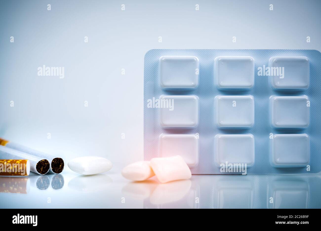 Nicotine chewing gum in blister pack near pile of cigarette. Quit
