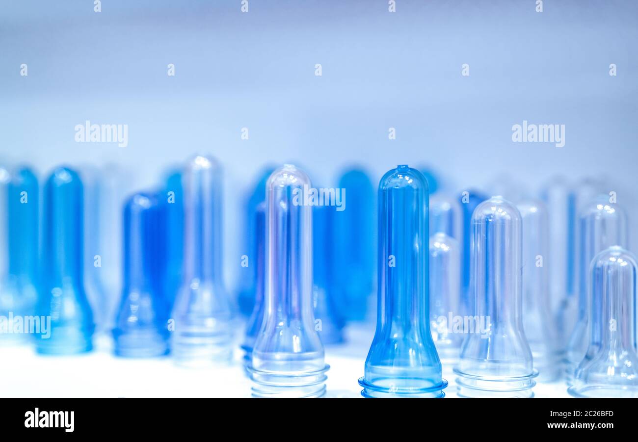PET bottle preforms before blow molding, filling and labeling process. Blue PET bottle preforms for beverage industry. Raw material for PET bottle wit Stock Photo