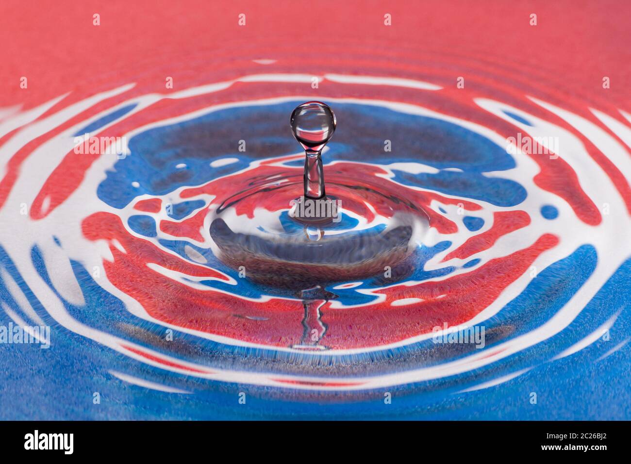 Red and blue water splash droplet macro. Stock Photo