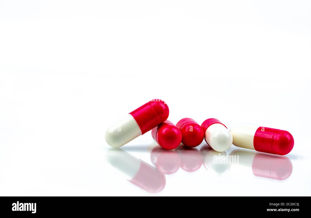 Red-white antibiotic pill isolated on white background. Antibiotic drug resistance. Antimicrobial capsule pills. Pharmacy drugstore symbol. Ph Stock Photo - Alamy