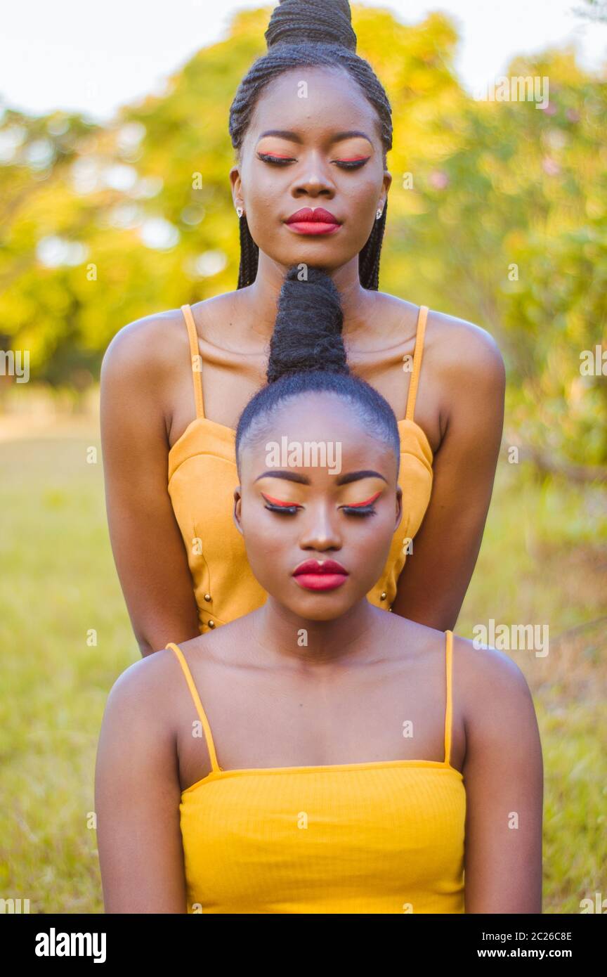 Twin photoshoot behind a gold background Stock Photo