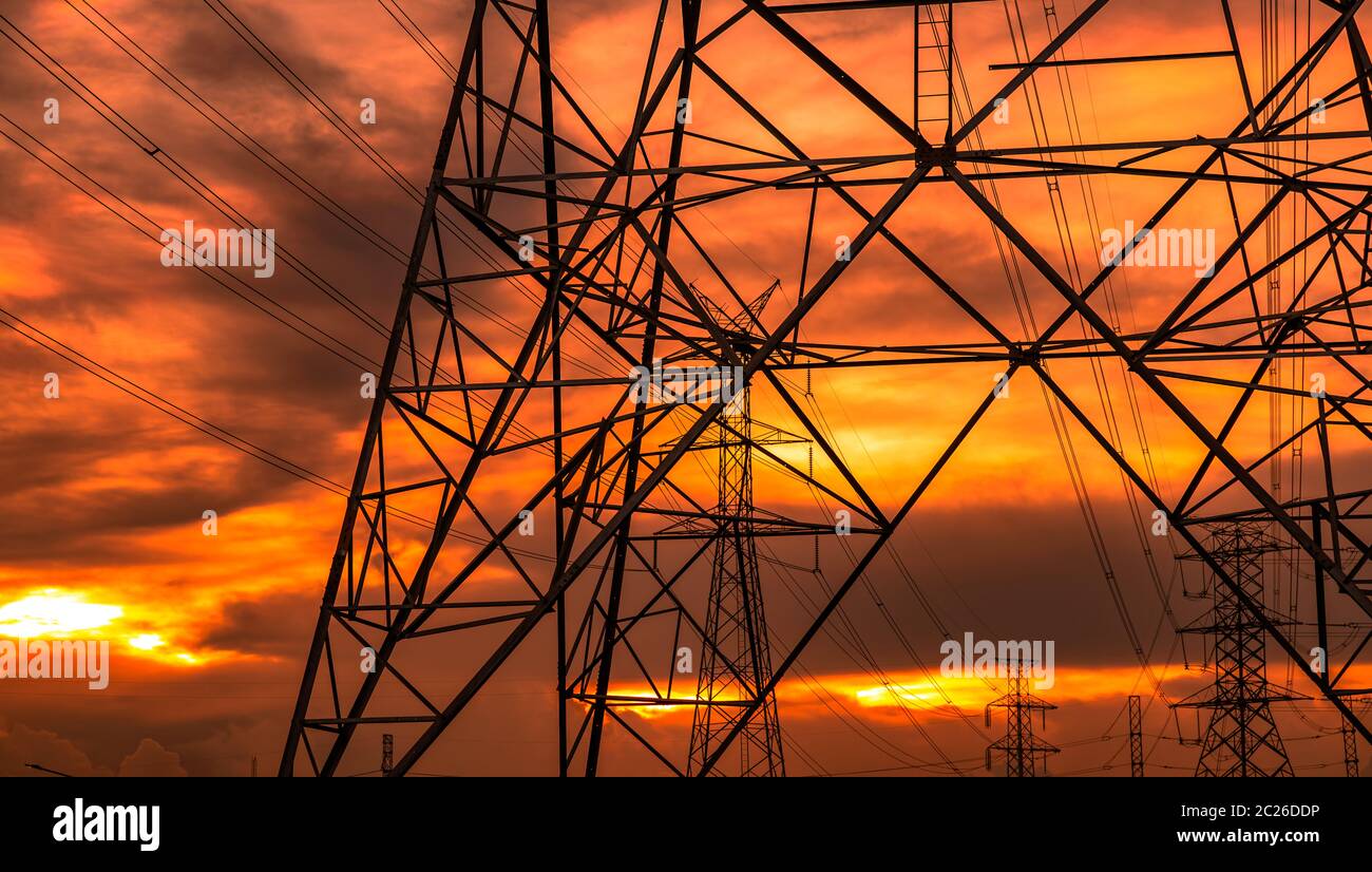 High voltage electric pole and transmission lines in the evening ...
