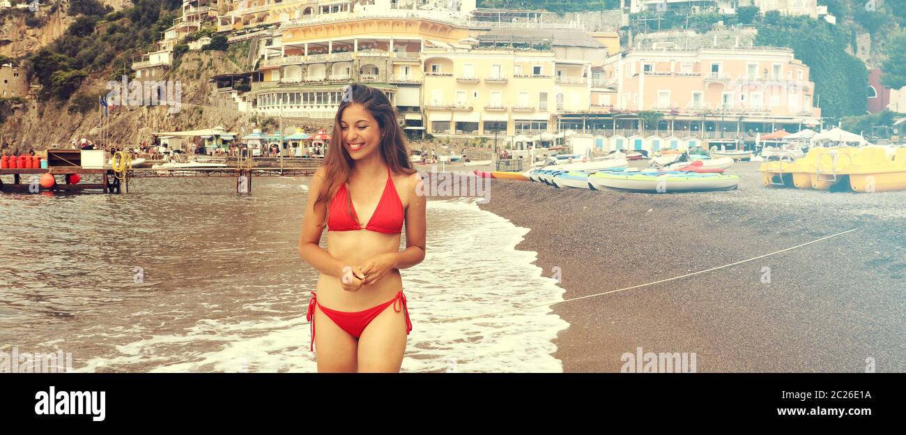 Beautiful bikini girl playing in Positano beach, Amalfi Coast, Italy.  Banner panorama. Retro vintage filter Stock Photo - Alamy