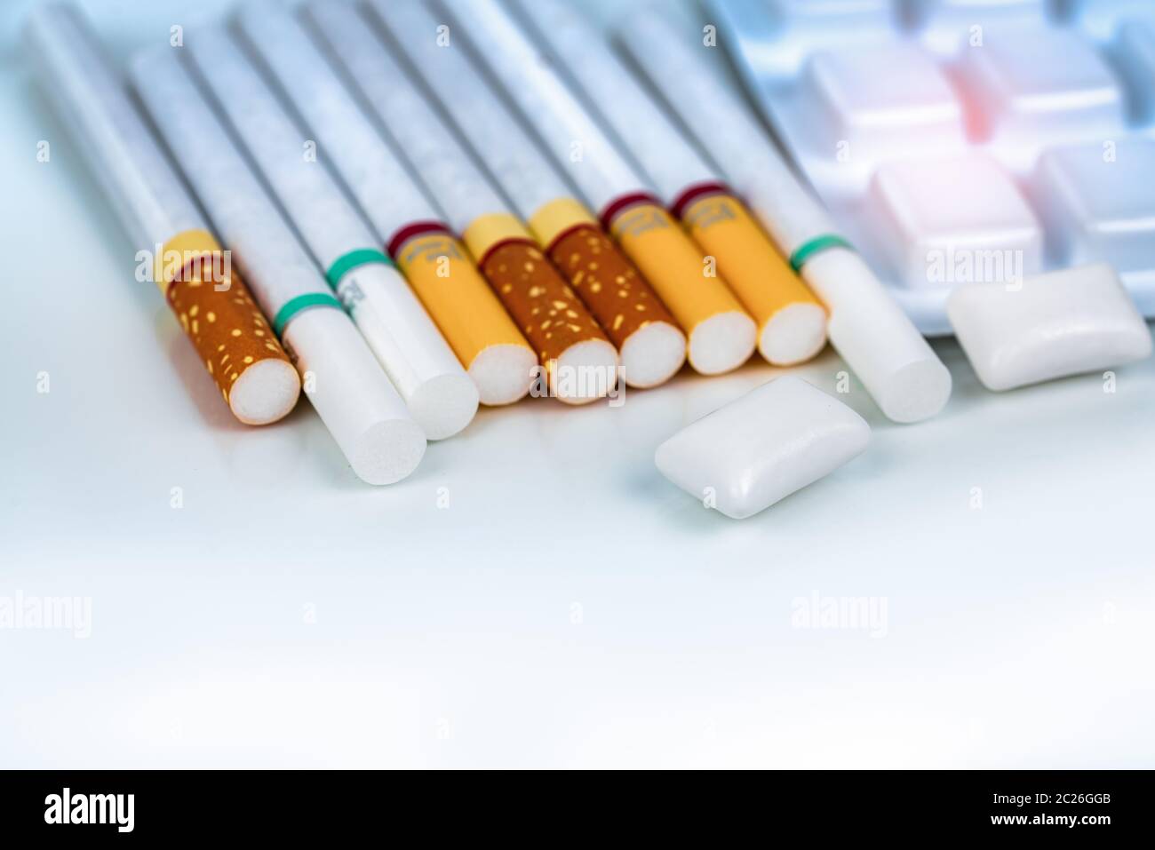 Nicotine chewing gum in blister pack near pile of cigarette. Quit