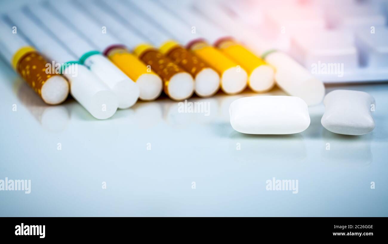 Nicotine chewing gum in blister pack near pile of cigarette. Quit