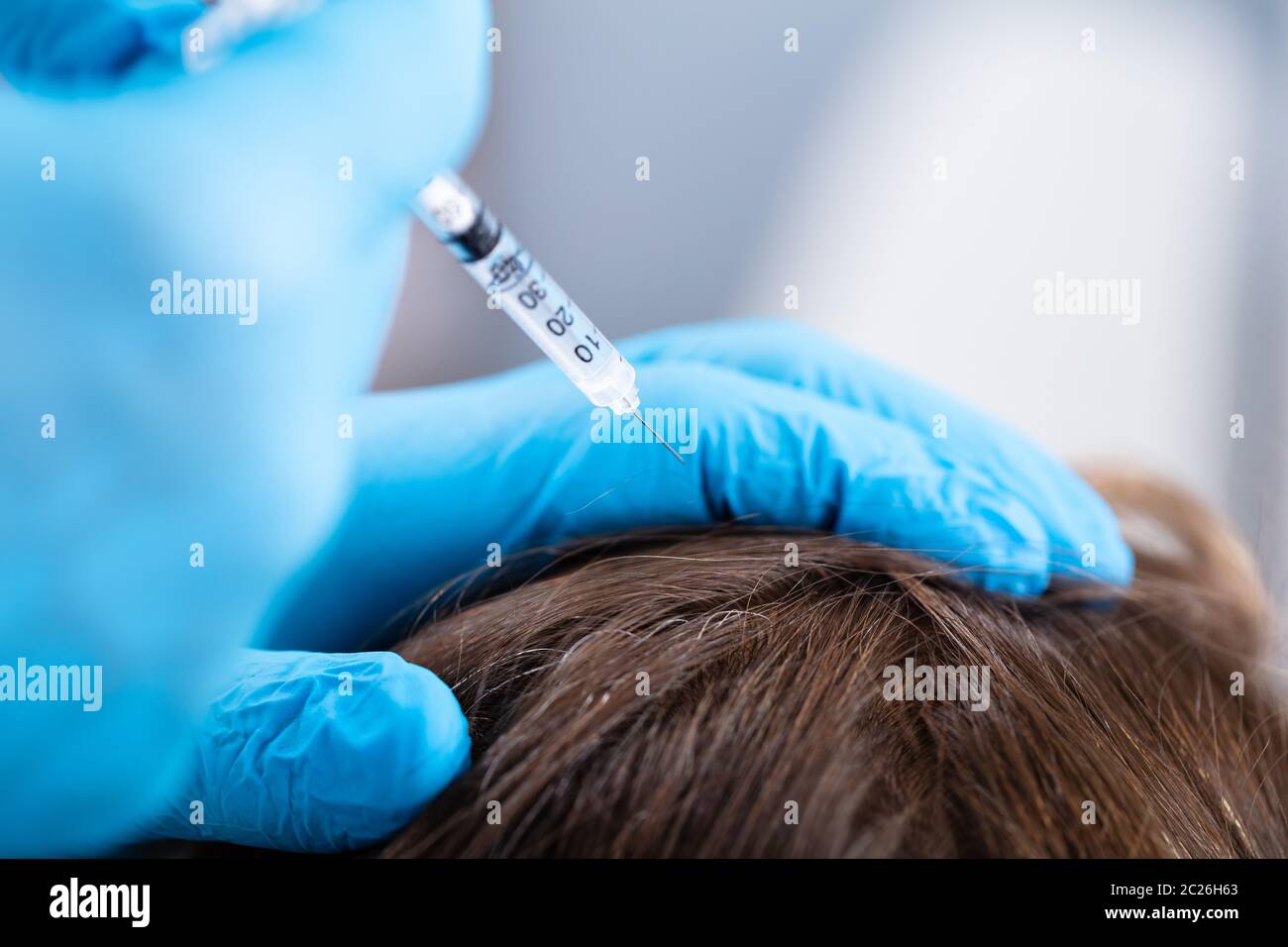 Doctor Giving Injection To His Patient For Hair Fall Stock Photo