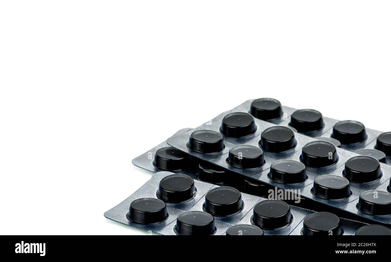 Activated charcoal tablets pills in blister pack isolated on white