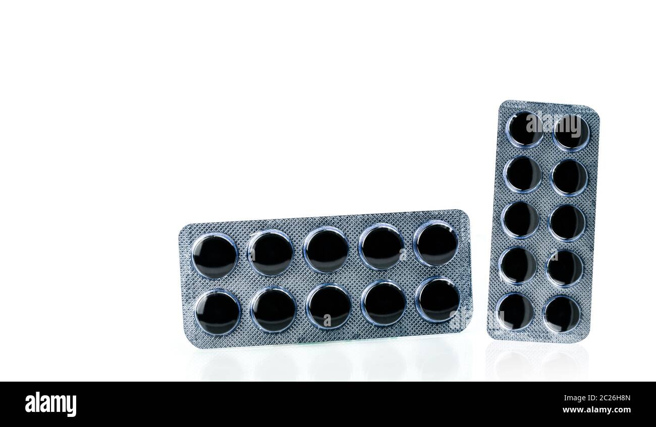 Activated charcoal tablets pills in blister pack isolated on white