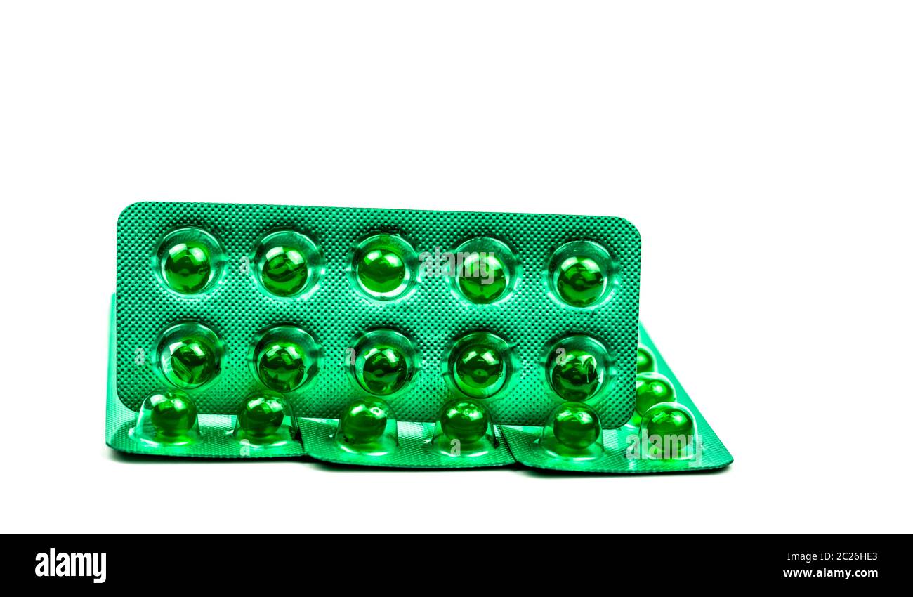 Green round soft capsule pills isolated on white background with copy