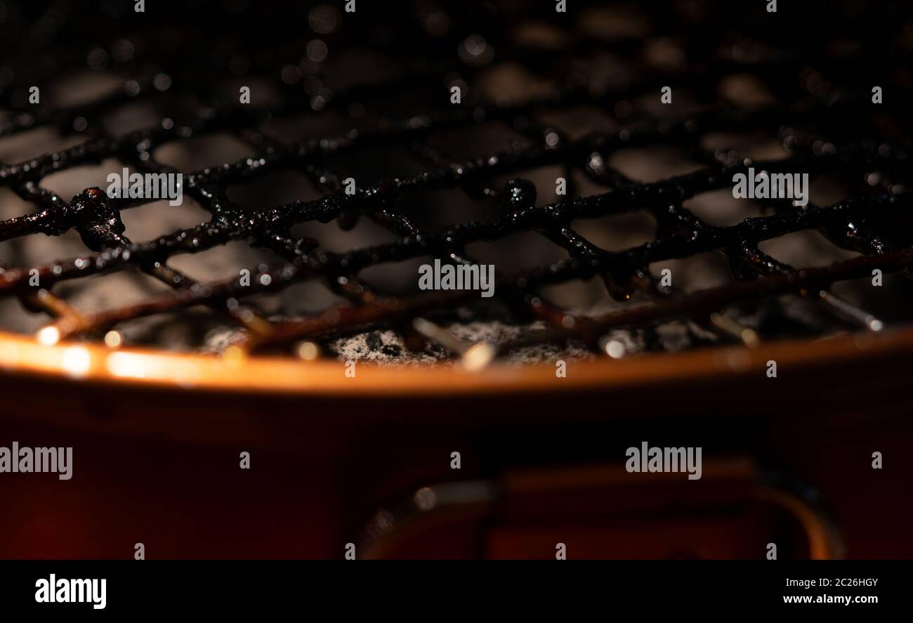 Closeup of dirty and burnt barbecue grill grates. Risk factor of cancers. Unhealthy food. Full