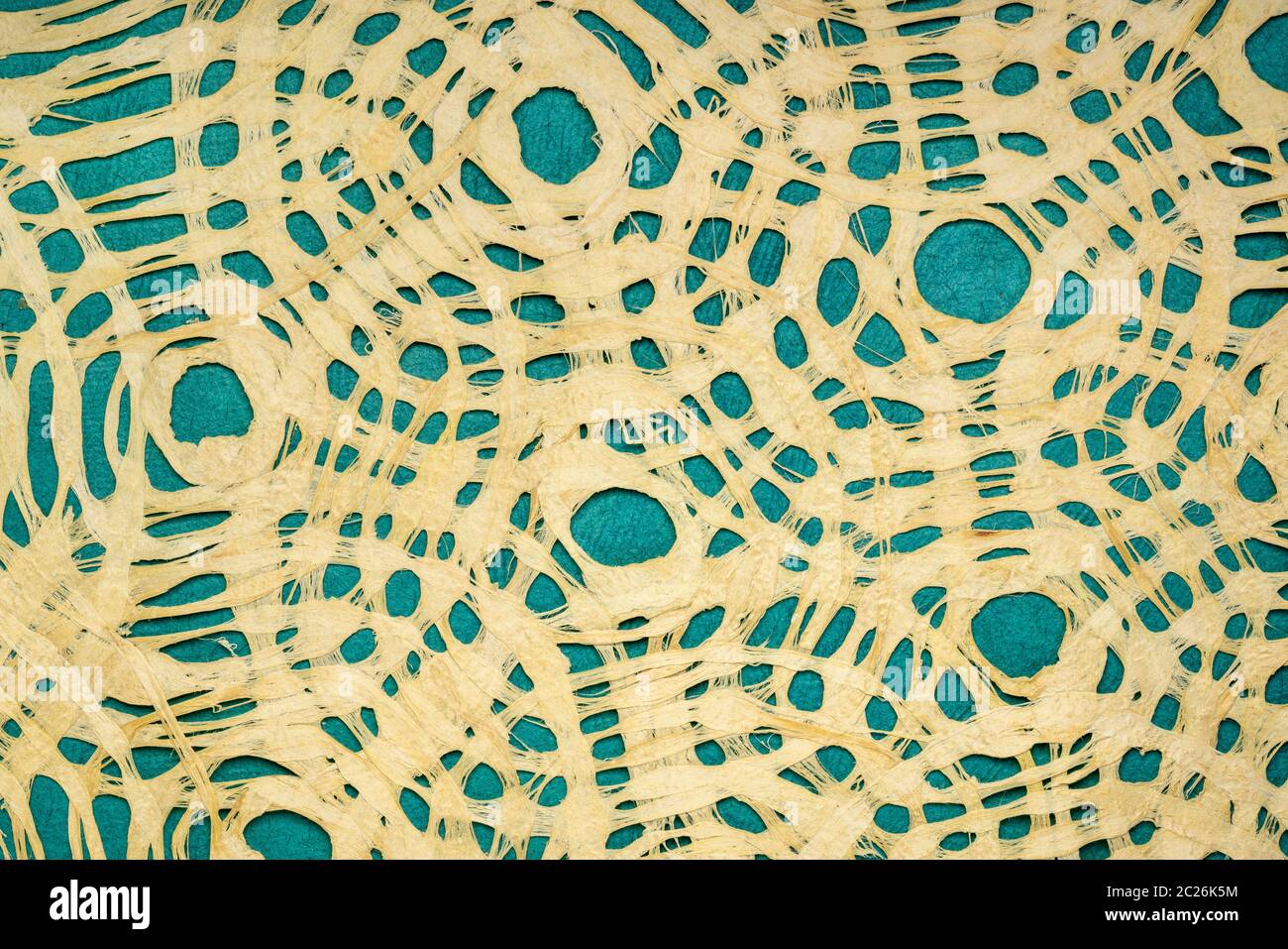 Amate bark paper with circular design against turquoise huun paper.  This ancient paper dates back to pre-Columbian and Meso-American times and is sti Stock Photo