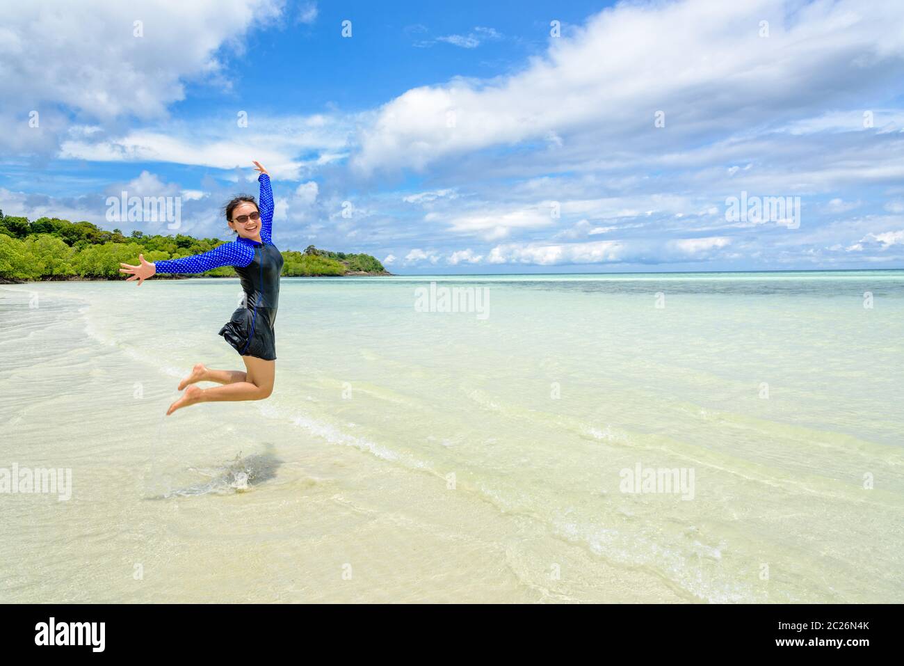 Happy girl jumping blue sky hi-res stock photography and images - Alamy