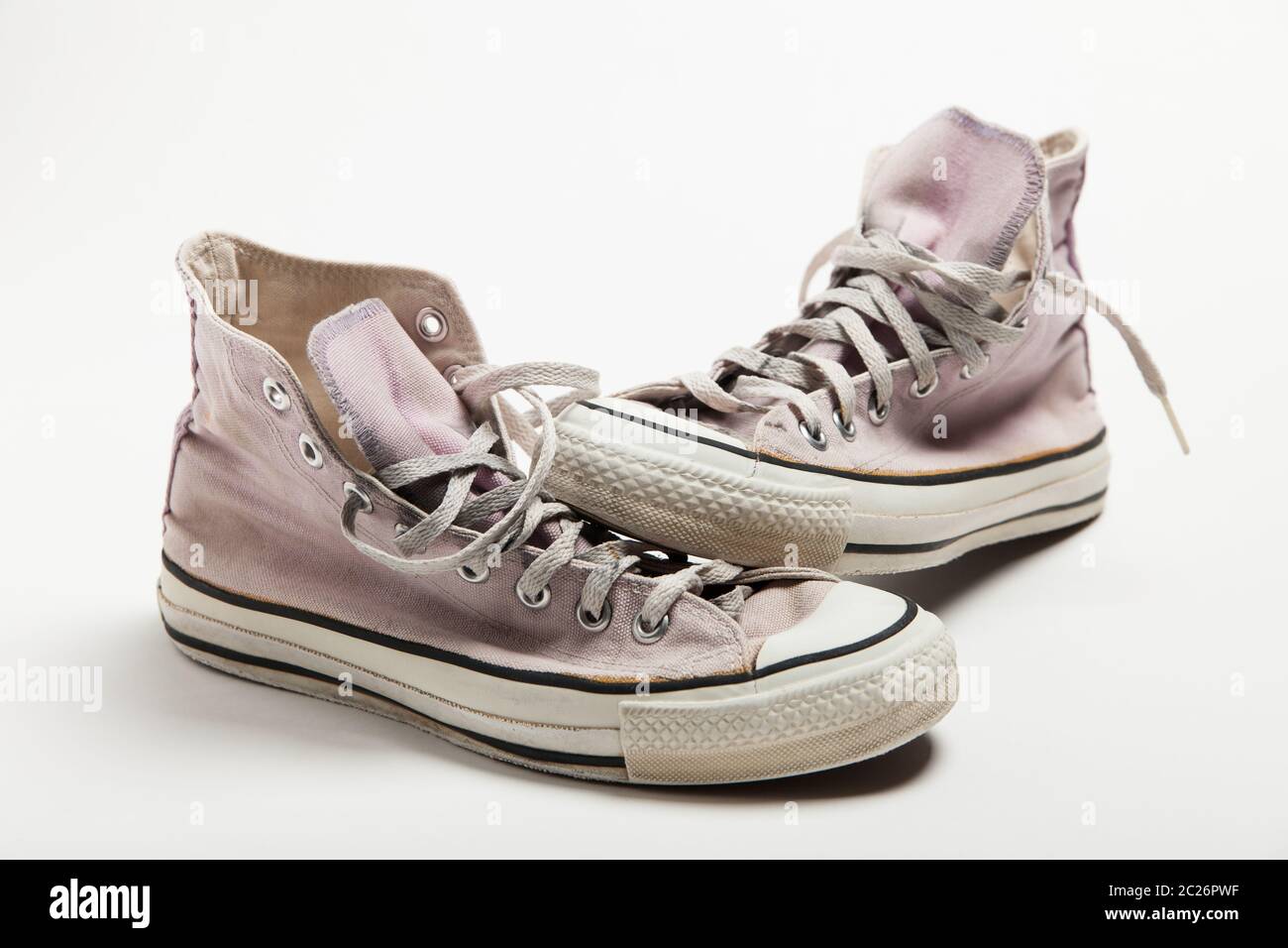 A pair of pink old basketball sneakers isolated on white background ...