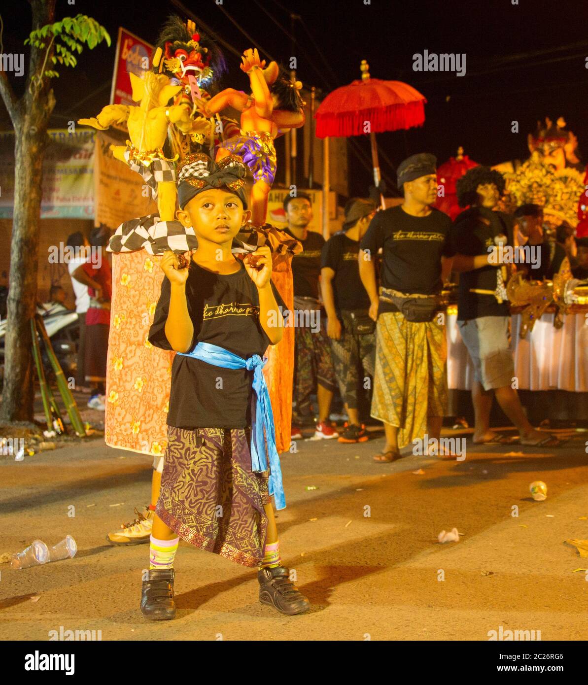 Boy with Nyepi figures, Bali Stock Photo