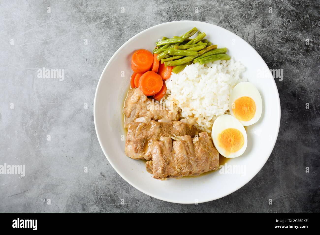 Baked pork ribs with rice, boiled egg and vegetable Stock Photo Alamy